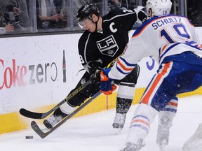 Edmonton Oilers defenseman Justin Schultz (19) defends Los Angeles Kings right wing Dustin Brown (23) during the second period of the game at Staples Center.  Jayne Kamin-Oncea-USA TODAY Sports