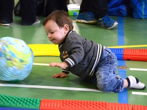 A young child plays with an inflatable globe during the Second annual Children's Festival at the Centennial Centre on Saturday April 11, 2015 in Bonnyville, Alta. Peter Lozinski/Cold Lake Sun/Postmedia Network