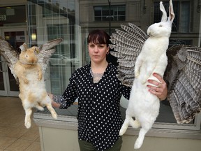 Fanshawe art student Kery Maddison shows one of her art exhibits that was removed from the window of The Arts Project on Dundas Street. (MORRIS LAMONT, The London Free Press)