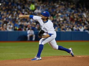 R.A. Dickey's throws his first pitches in the 1st inning at  the Toronto Blue Jays home opener against the Tampa Bay Rays at the Rogers Centre in Toronto, Ont. on Monday April 13, 2015. Stan Behal/Toronto Sun/Postmedia Network