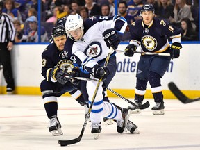 St. Louis Blues centre Olli Jokinen reaches for the puck on Winnipeg Jets defenceman Tyler Myers during the second period at Scottrade Center on April 7, 2015. (Jasen Vinlove/USA TODAY Sports)