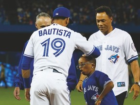 Jays slugger Jose Bautista and Roberto Alomar helped Ben Sheppard throw out the first pitch at the opening ceremonies last night. MLB commissioner Rob Manfred was also on hand. (STAN BEHAL/Toronto Sun)