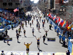 Runners stream down Boylston Street at the exact minute one year ago the first bomb exploded near the finish line during the 2014 Boston Marathon.
Greg M. Cooper-USA TODAY Sports