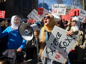 Hayday Gadalla, center, leads the chants during a rally and march around Victoria Park to protest the Ontario government's new sex education curriculum on Tuesday April 14, 2015. (MORRIS LAMONT, The London Free Press)