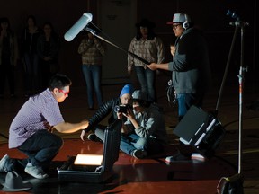 Trey Shining Double (left), 16, from Piikani, is creatively lit while playing the villain during the filming of a short action sequence. Aaron Bernakevitch (blue hat) advises director Nathaniel Metchooyeah, 13, as Michael Big Bull, 16, operates the boom microphone during the 7th annual Piikani Youth Forum on April 9, 2015. John Stoesser photos/QMI Agency.