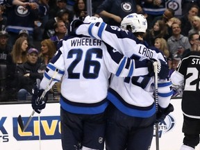 Blake Wheeler and Andrew Ladd hug it out after a power play goal March 29 vs. the Kings.
