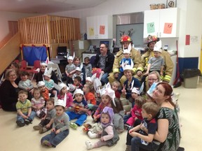 Children and staff at the Cochrane Child care Centre pose with two members of the local fire department after hoping for two minutes wearing their bunny ears. The annual campaign is organized in recognition of Muscular Dystrophy and the child care centre raised more than $800 for MD.