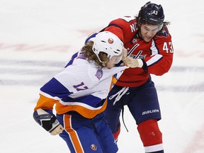 Washington Capitals winger Tom Wilson (43) fights New York Islanders left wing Matt Martin (17) during NHL play at the Verizon Center. (Geoff Burke/USA TODAY Sports)