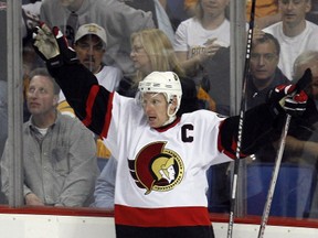 Then-Ottawa Senators captain Daniel Alfredsson (top) celebrates with teammate Dany Heatley after scoring the winning goal in overtime against the Buffalo Sabres' in Game 5 of the NHL's Eastern Conference final hockey series in Buffalo, New York, May 19, 2007. With the win, the Ottawa Senators advance to the Stanley Cup.