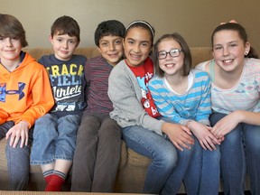 Mexican students Chris Alcanadara, centre left, and Sam Franco, centre right, are among a contingent from Mexico City on a four-week visit to Sarnia through a Lambton Kent District School Board international education program. Alcanadara has been billetting with Matthew, left, and Michael Davies and their parents, and Franco with Carly, second from right, and Kaitlyn Unsworth and their parents. (Tyler Kula/Sarnia Observer/Postmedia Network)