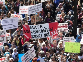 Protesters gather on the lawn at Queen's Park to rally against the government's new sex education curriculum on Tuesday April 14, 2015. (Craig Robertson/Toronto Sun)