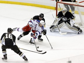 New York Rangers center J.T. Miller (10) attempts a shot as Pittsburgh Penguins center Brandon Sutter (16) and defenseman Simon Despres (middle) and goalie Thomas Greiss (1) defend during the second period at the CONSOL Energy Center. The Rangers won 5-2.  Charles LeClaire-USA TODAY Sports