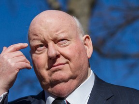 Suspended Senator, Mike Duffy scratches his eyebrow while waiting for his car at the courthouse on Elgin Street Tuesday in Ottawa on April 14, 2015. (Joel Watson/Ottawa Sun/PostMedia Network)