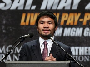 Manny Pacquiao speaks at the Floyd Mayweather v Manny Pacquiao Press Conference on March 11, 2015 in Los Angeles, California.  Stephen Dunn/Getty Images/AFP