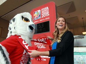 Zara Lang clowns around with World Cup mascot Shueme by the countdown clock at city hall on Tuesday. (Perry Mah, Edmonton Sun)