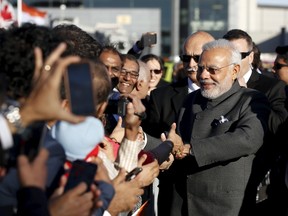 India's Prime Minister Narendra Modi greets onlookers after arriving at the Ottawa International Airport April 14, 2015. (REUTERS/Chris Wattie)