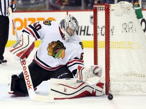 Chicago Blackhawks goalie Corey Crawford makes a save against the Winnipeg Jets at MTS Centre. (Bruce Fedyck/USA TODAY Sports)