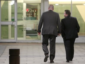 OTTAWA, ONT. (04/14/2015) Ottawa Police Investigations Unit's Chris Benson, left, enters 2020 Jasmine Crescent Tuesday night with a fellow investigator. Police are investigating a stabbing earlier in the day at the address. Andrew Meade/Ottawa Sun/Postmedia Network