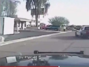 Screen grab from a dashcam video showing an Arizona police cruiser run down a suspect carrying a shotgun in Marana. (YouTube)