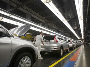 Production Associates inspect cars moving along assembly line at Honda manufacturing plant in Alliston, Ontario March 30, 2015. (REUTERS/Fred Thornhill)