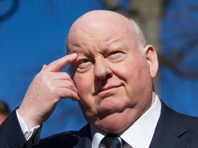 Suspended Senator Mike Duffy scratches his eyebrow while waiting for his car at the courthouse on Elgin Street Tuesday.  Joel Watson/Ottawa Sun/PostMedia Network