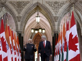 Canada's Prime Minister Stephen Harper (R) walks in the Hall of Honour with India's Prime Minister Narendra Modi on Parliament Hill in Ottawa April 15, 2015. REUTERS/Chris Wattie