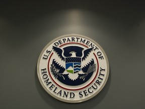 The logo of the Department of Homeland Security is seen at US Immigration and Customs Enforcement in Washington, DC, February 25, 2015. AFP PHOTO / SAUL LOEB