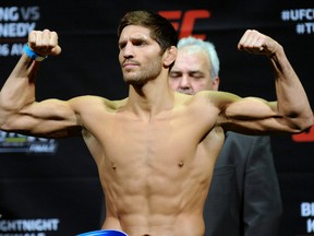 Patrick Cote flexes during his official weigh-in for a UFC fight on April 15, 2014 in Quebec City. (SIMON CLARK/JOURNAL DE QUEBEC/QMI AGENCY)