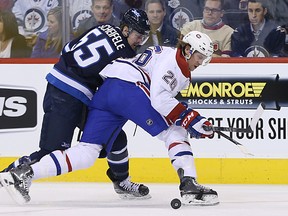 Winnipeg Jets centre Mark Scheifele (left) is cut off by Montreal Canadiens defenceman Nathan Beaulieu during NHL action at MTS Centre in Winnipeg, Man., on Thu., March 26, 2015. Kevin King/Winnipeg Sun/QMI Agency