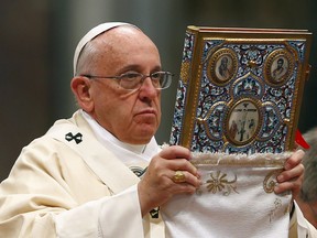 Pope Francis blesses the missal as he leads a mass on the 100th anniversary of the Armenian mass killings, in St. Peter's Basilica at the Vatican April 12, 2015. Pope Francis on Sunday commemorated the 100th anniversary of the massacre of as many as 1.5 million Armenians as "the first genocide of the 20th century," words that could draw an angry reaction from Turkey. REUTERS/Tony Gentile