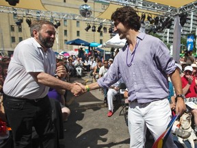 Liberal leader Justin Trudeau (R) shakes hands with New Democrat Party leader Thomas Mulcair before the gay pride parade in Toronto, June 30, 2013.    REUTERS/Mark Blinch