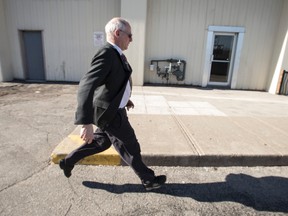 Ben Levin runs for a waiting vehicle after another day in his sentencing hearing at the Finch Ave courthouse on April 15, 2015. (Craig Robertson/Toronto Sun)