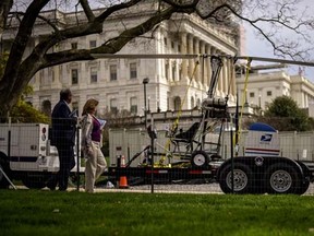 People walk past a gyro copter that was flown onto the grounds of the U.S. Capitol before it was towed from the west front lawn in Washington April 15, 2015.  REUTERS/James Lawler Duggan