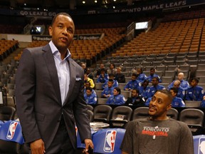 Former Raptors Damon Stoudamire (left) and Jamaal Magloire  chat before the start of last night’s game. (Jack Boland/Toronto Sun)