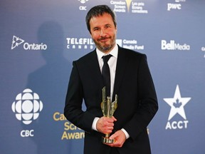 Director Denis Villeneuve holds his award for Best Director for "Enemy" at the 2014 Canadian Screen awards in Toronto, March 9, 2014.    REUTERS/Mark Blinch