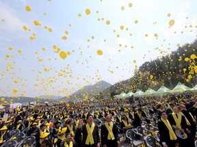 Mourners release yellow coloured balloons dedicated to the victims during a memorial ceremony to mark the first anniversary of the ferry disaster that killed more than 300 passengers, at a port in Jindo on April 16, 2015. (REUTERS/Yonhap)
