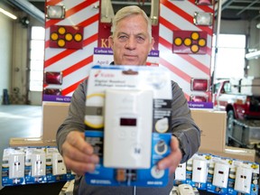 John Gignac, co-chair of the Hawkins-Gignac Foundation, holds a carbon monoxide detector at the London Fire Department headquarters on Horton St. in London on Thursday. Craig Glover/The London Free Press/Postmedia Network