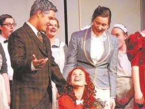 Eric Brouwer plays Oliver Warbucks and Julia Hoytema plays Annie, in the London District Christian Secondary School production of Annie.