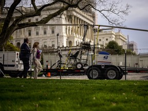 People walk past a gyro copter that was flown onto the grounds of the U.S. Capitol before it was towed from the west front lawn in Washington April 15, 2015. (REUTERS/James Lawler Duggan)