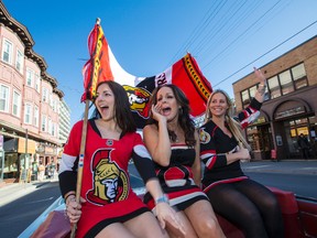 Sens fans Allison Vaillancourt, Tammy Laverty, and Jenn Morgan whoop it up from the back seat of a 1964 Cadillac Deville as they ride down The Sens Mile prior to the opening game of the NHL playoffs between the Ottawa Senators and the Montreal Canadiens. Wednesday April 15, 2015. (Errol McGihon/Ottawa Sun/Postmedia Network)