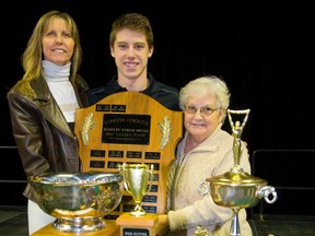Mitch Marner is flanked by his mom Bonnie and grandmother Sandra Viau after picking up four trophies ? MVP (shared with Max Domi), Molson Cup three-star trophy, playoff performer of the year and the highest scorer ? as the London Knights handed out team awards at Budweiser Gardens on Thursday. (MIKE HENSEN, The London Free Press)