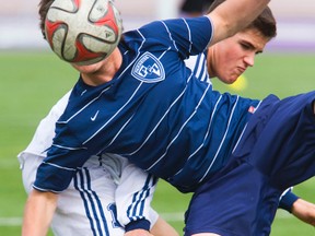 St. Thomas Parkside?s Scott Higgs is obscured by the ball as he battles Jared Nash of Stratford St. Mike?s during a game at the high school soccer tournament at Western University on Thursday. (MIKE HENSEN, The London Free Press)