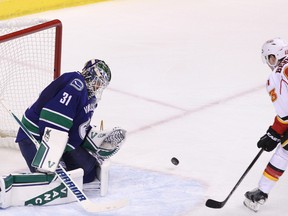 Vancouver Canucks goalie Eddie Lack stops a shot from Calgary Flames'  Sam Bennett during the second period of Game 1 in a first-round NHL Stanley Cup playoffs series in Vancouver on Wednesday. (Carmine Marinelli/Postmedia Network)