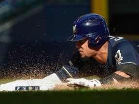 Milwaukee Brewers centre fielder Carlos Gomez dives back to first base during a game against the St. Louis Cardinals at Miller Park. (Benny Sieu/USA TODAY Sports)