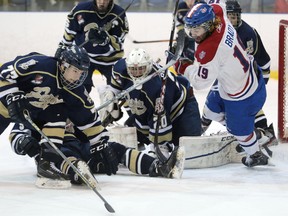 Adam Brady of the Kingston Voyageurs scrambles to fin the puck in front of the Toronto Patriots goal during the first period Thursday night at the Invista Centre. The Patriots won 2-1 in overtime to take a 3-1 lead in the series. (Elliot Ferguson/The Whig-Standard)