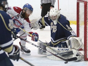 Spencer Green of the Kingston Voyageurs tries to slip the puck past Toronto Patriots goaltender Mathew Robson during the first period Thursday night at the Invista Centre. (Elliot Ferguson/The Whig-Standard)