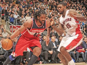 Amir Johnson (right) and Nene could be seeing a lot of each other in this first-round series. (GETTY IMAGES)