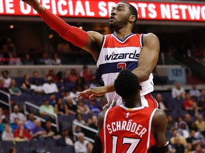 Washington Wizards guard John Wall (2) shoots the ball over Atlanta Hawks guard Dennis Schroder (17) on April 12, 2015. (GEOFF BURKE/USA TODAY Sports)