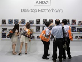 Visitors look at motherboards being displayed at the AMD booth during the 2012 Computex exhibition at the TWTC Nangang exhibition hall in Taipei in this file photo from June 6, 2012.   REUTERS/Yi-ting Chung/Files