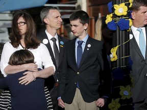The family of Boston Marathon bombing victim Martin Richard  joins Boston Mayor Marty Walsh (R) at a ceremony at the site of the second bomb blast on the second anniversary of the bombings in Boston, Massachusetts in this April 15, 2015, file photo. The parents of the boy who was the youngest to die in the attack on the Boston Marathon asked federal prosecutors to abandon their effort to sentence the bomber to death, in a statement on the front page of the Boston Globe on April 17, 2015. REUTERS/Brian Snyder/Files